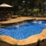 cancun inground swimming pool with stamped and dyed concrete and raised spa